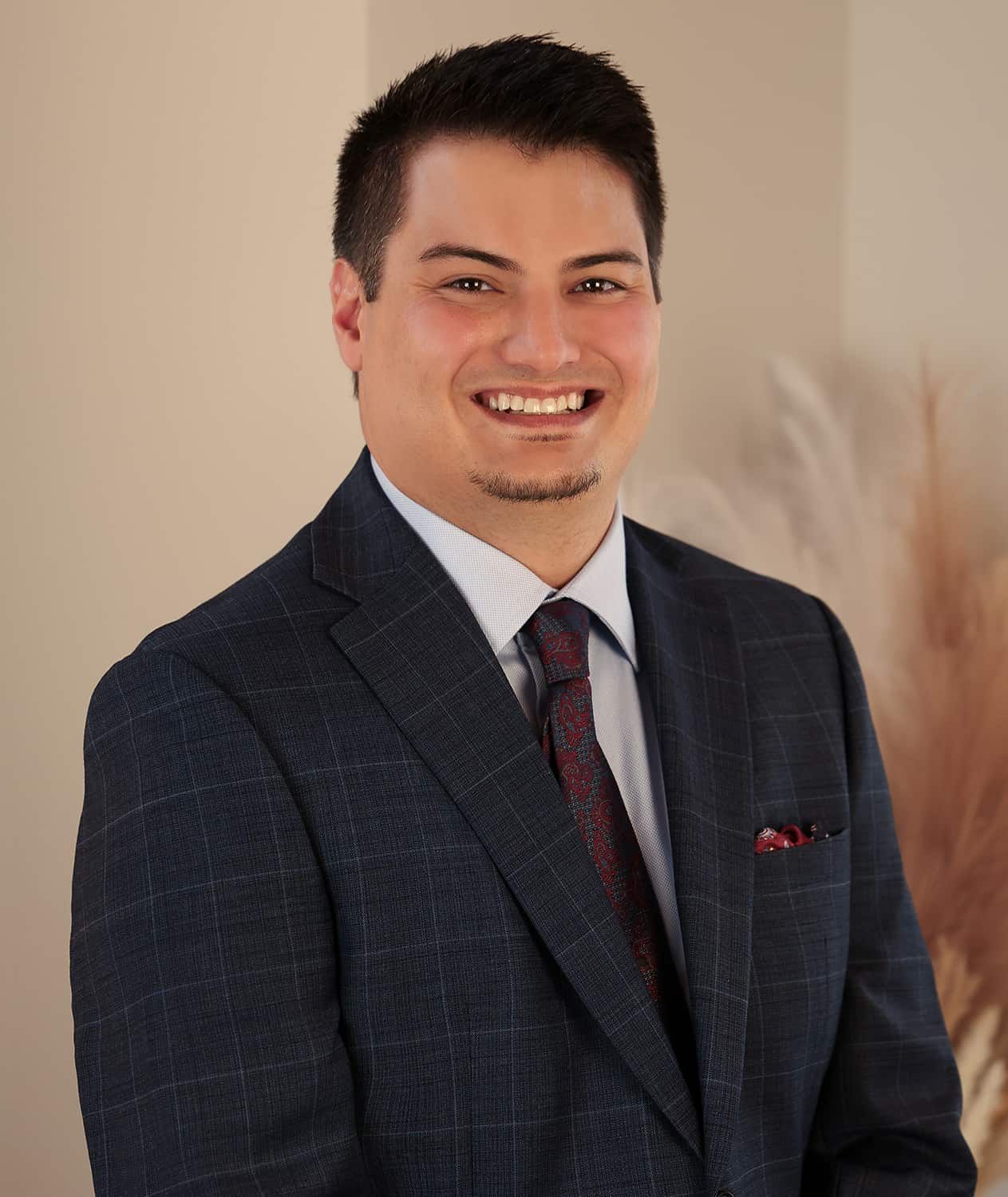 Woman in professional attire smiling warmly.