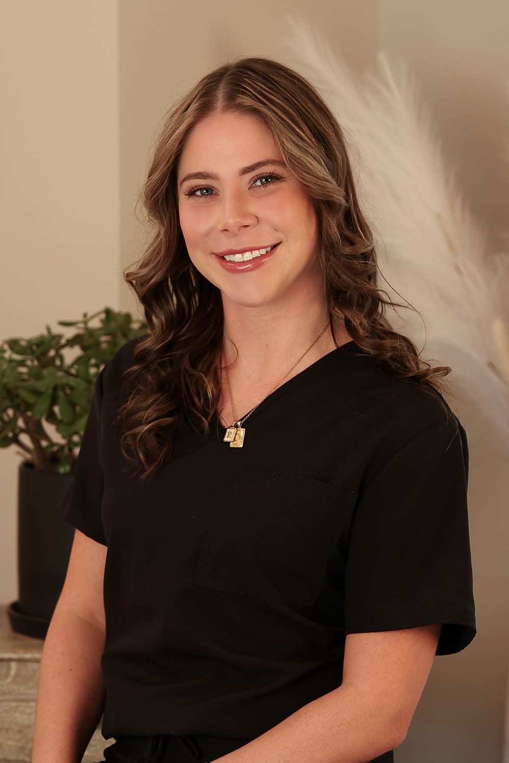 Woman smiling in professional black attire.