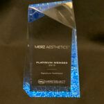 Award trophy with blue accents and engraved text.